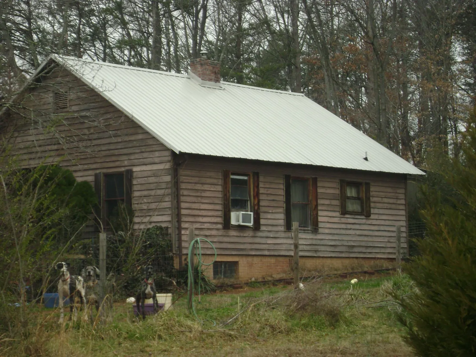 White metal roof on an old wood sided farmhouse, from a Metal Roof Installation job in Riverdale